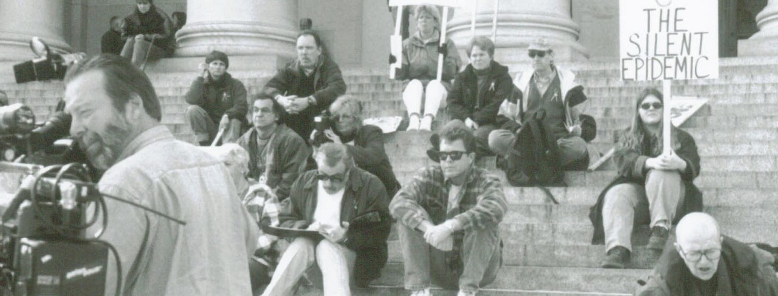 People at a protest sitting on steps