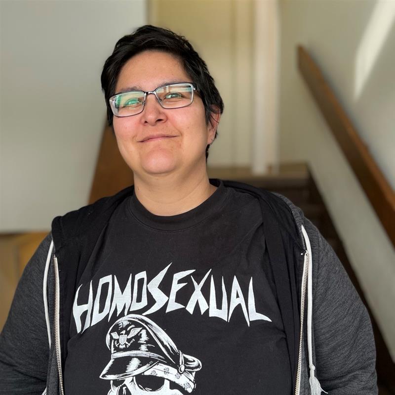 Amber Tejada is smiling and wearing a t-shirt that says "Homosexual Tendencies"